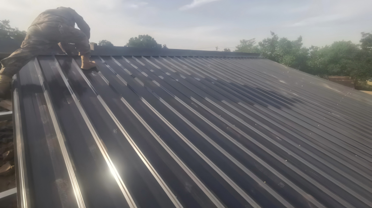 Metal roof panels are being installed. Metal roof panels are being installed.